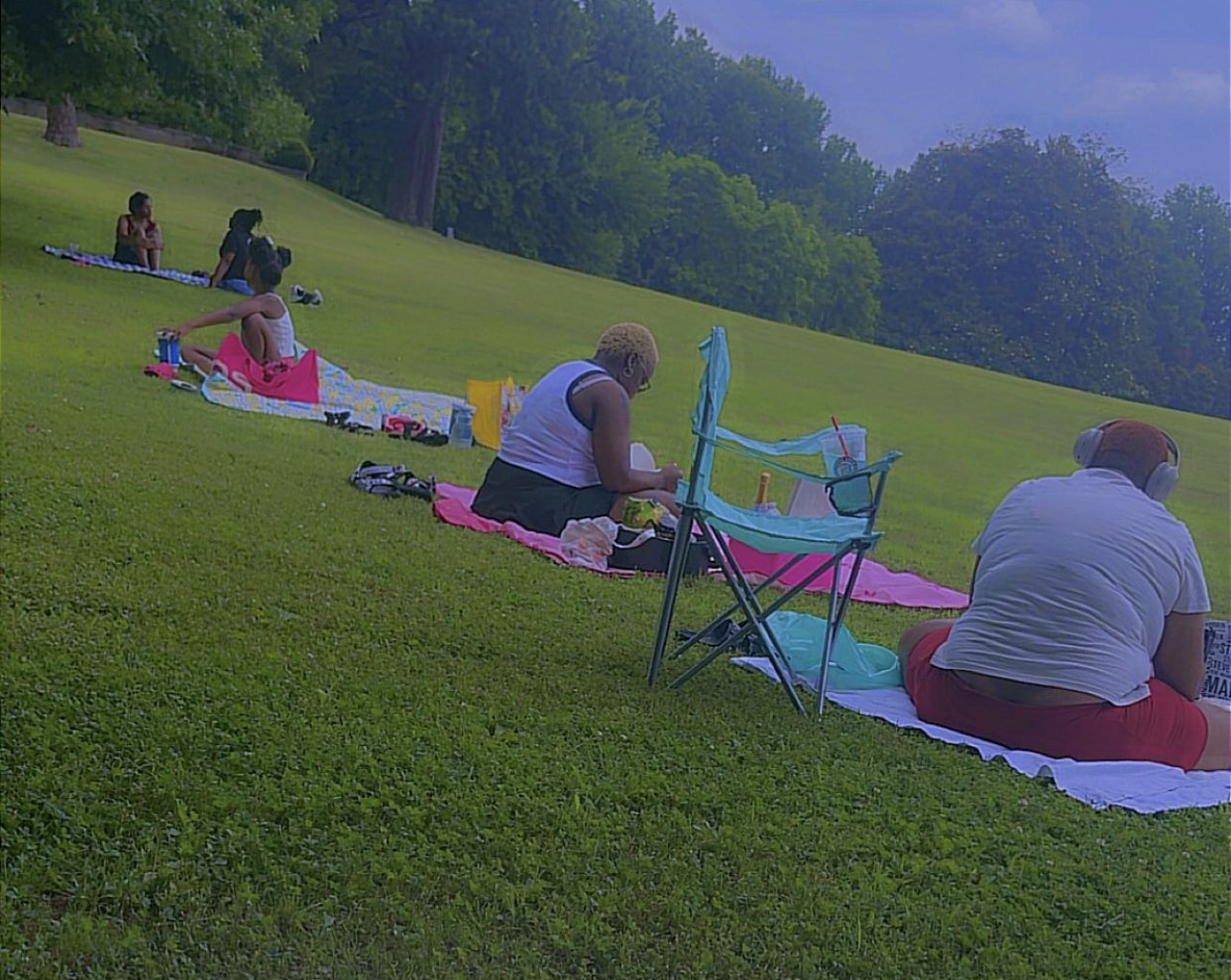 Books and Babes members relaxing together at an outdoor reading picnic